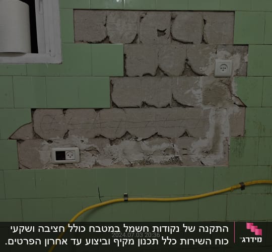 קיר עם שקעי חשמל וצינור צהוב